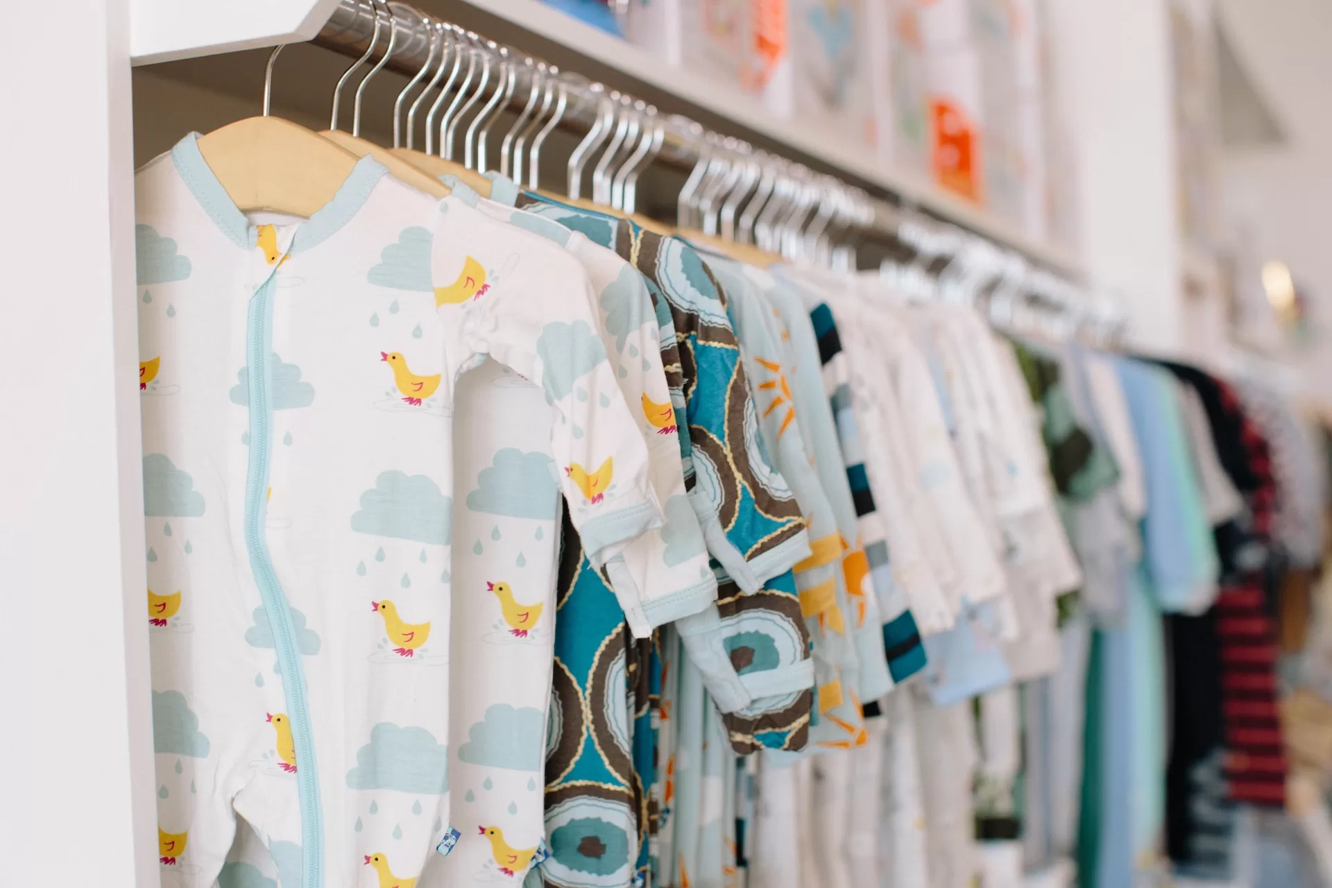 shopping for baby clothing on a rack